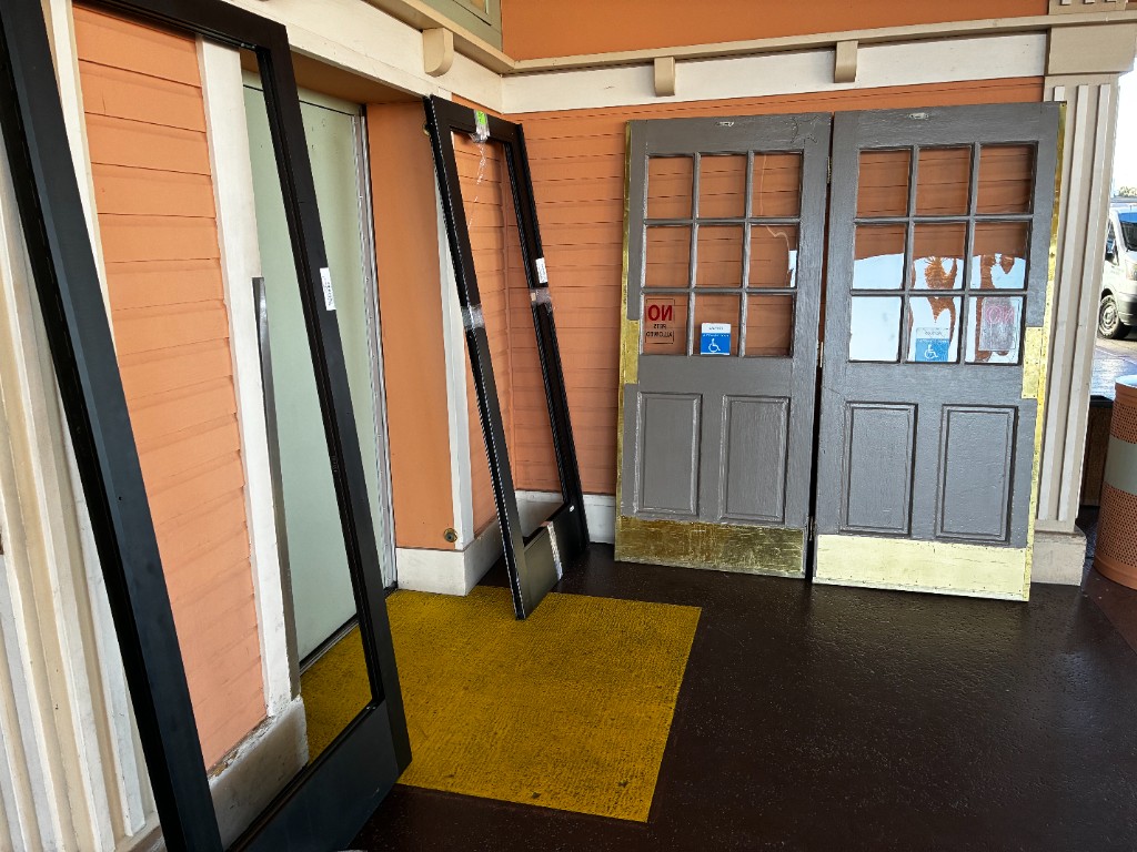 Before storefront entry with worn doors removed during modernization