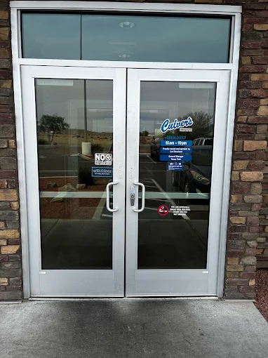Commercial glass storefront entrance with aluminum frames and stone facade