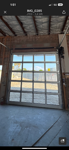 Full-view aluminum and glass commercial sectional door with side-mounted operator